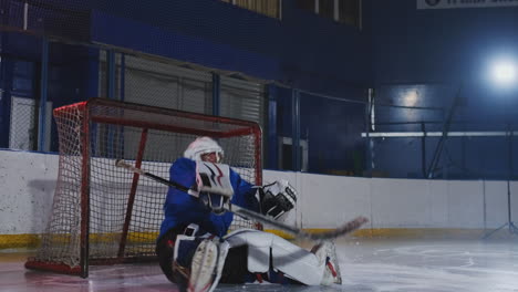 Hockey-player-conducts-an-attack-on-the-opponent's-goal.-Lying-in-a-helmet-catches-the-puck-and-saves-the-match.-Hockey-player-man-of-the-match